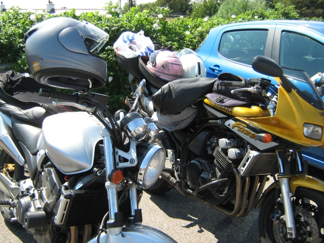2 motorcycles covered in motorcycle gear outside the cafe in gairloch
